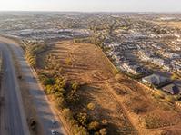 Aerial view of open land at an urban edge
